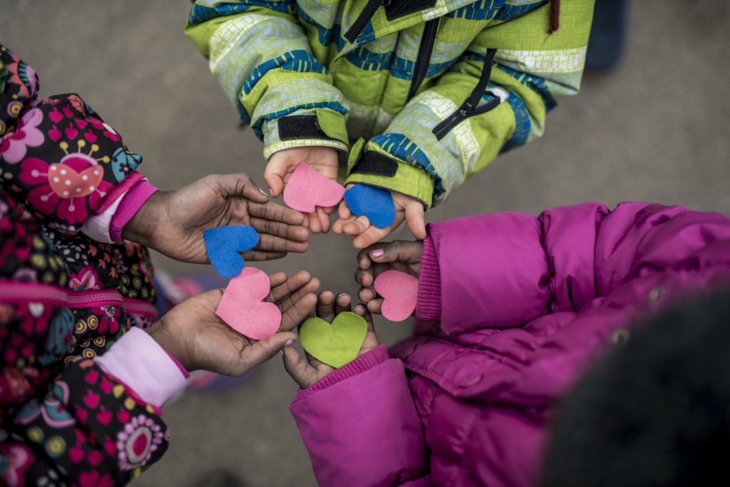 Children holding hearts in hands